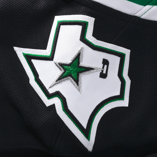 Embroidered logo on a black hockey jersey with a star and shield design