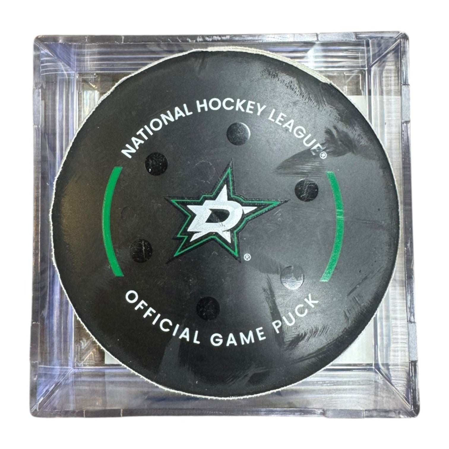 A Dallas Stars NHL official game/goal puck inside a clear plastic protective case, shown against a plain white background.