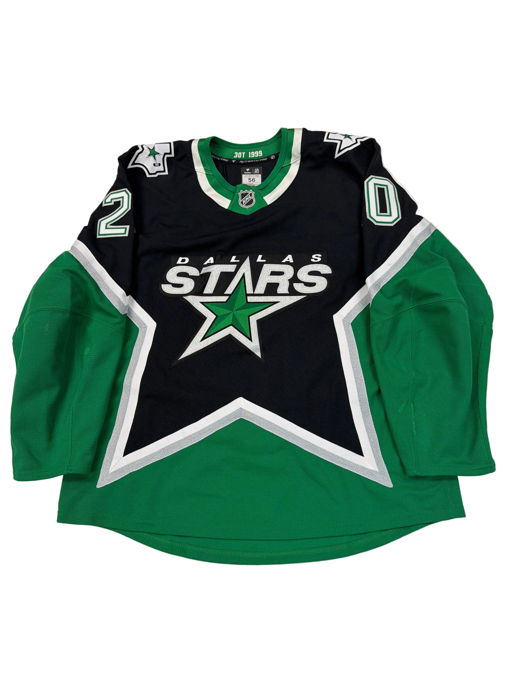 Folded sports jersey with a star logo on a white surface