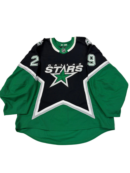 Green and black sports jersey with star logo on a white surface