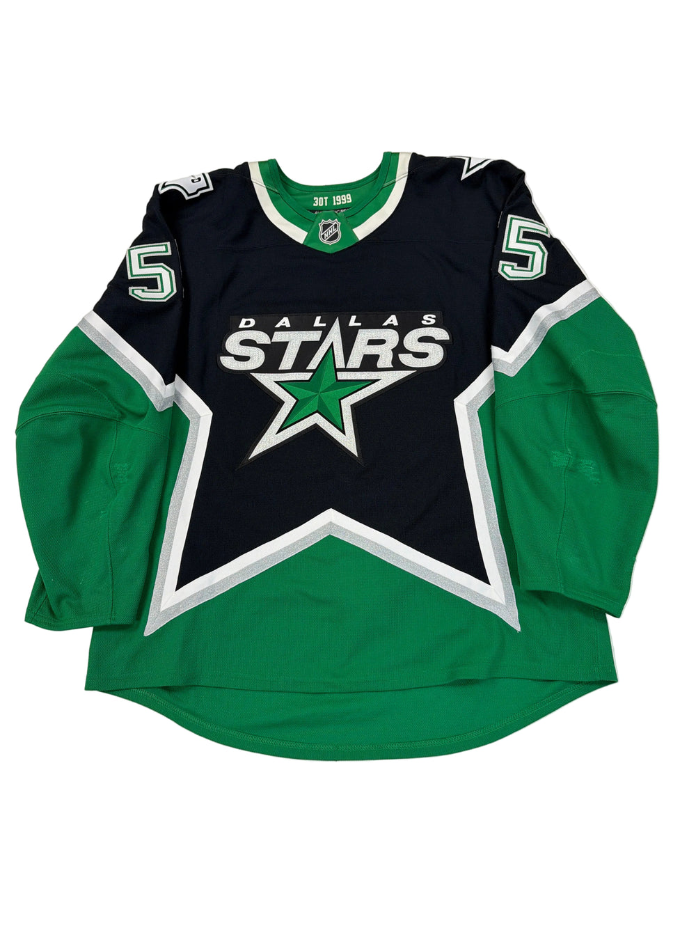 Green and black sports jersey with a star logo on a white floor.