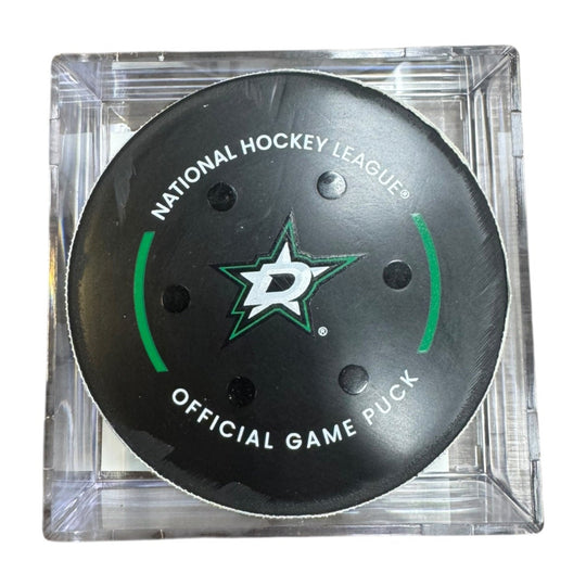 A Dallas Stars NHL official game/goal puck inside a clear plastic protective case, shown against a plain white background.