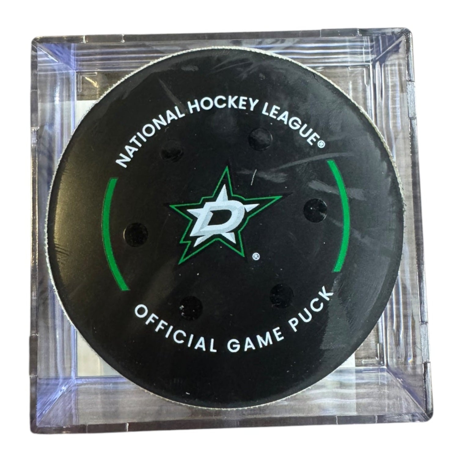 A Dallas Stars NHL official game/goal puck inside a clear plastic protective case, shown against a plain white background.