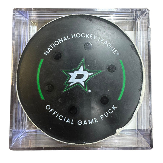 A Dallas Stars NHL official game/goal puck inside a clear plastic protective case, shown against a plain white background.