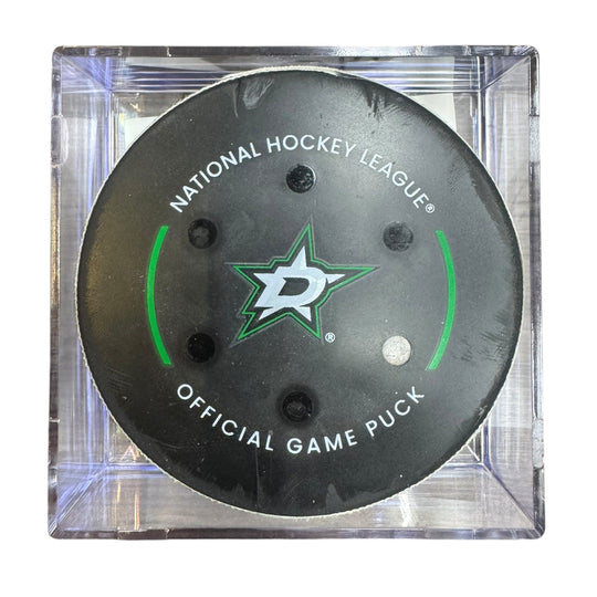 A Dallas Stars NHL official game/goal puck inside a clear plastic protective case, shown against a plain white background.