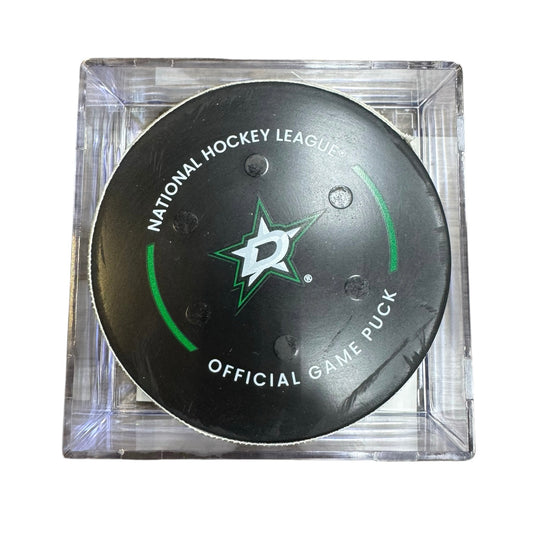 A Dallas Stars NHL official game/goal puck inside a clear plastic protective case, shown against a plain white background.