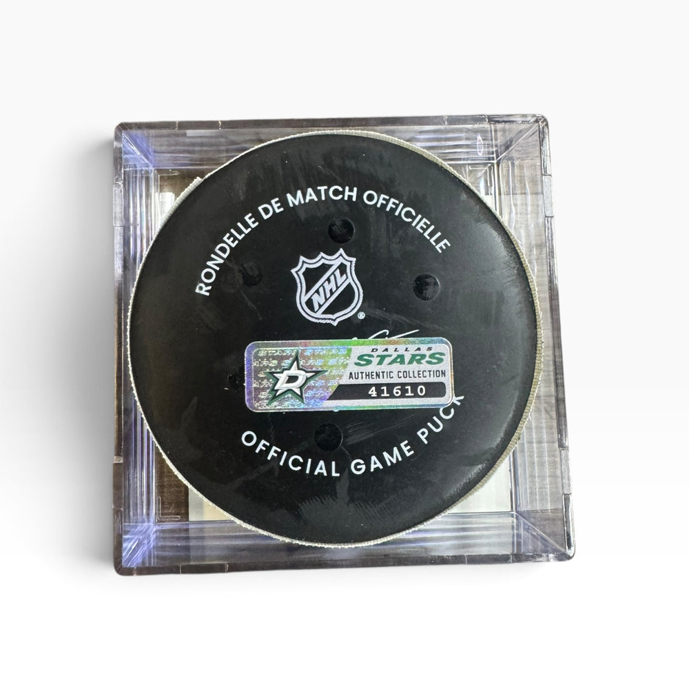 An official NHL Dallas Stars collectible hockey puck inside a clear plastic protective case, shown on a white background.