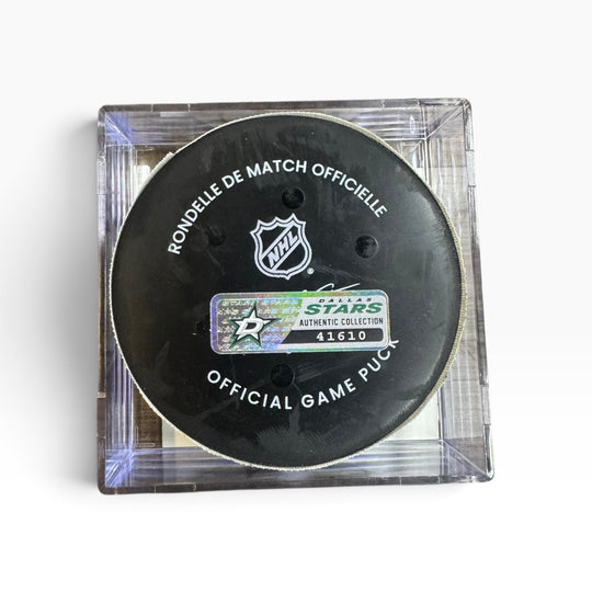 An official NHL Dallas Stars collectible hockey puck inside a clear plastic protective case, shown on a white background.