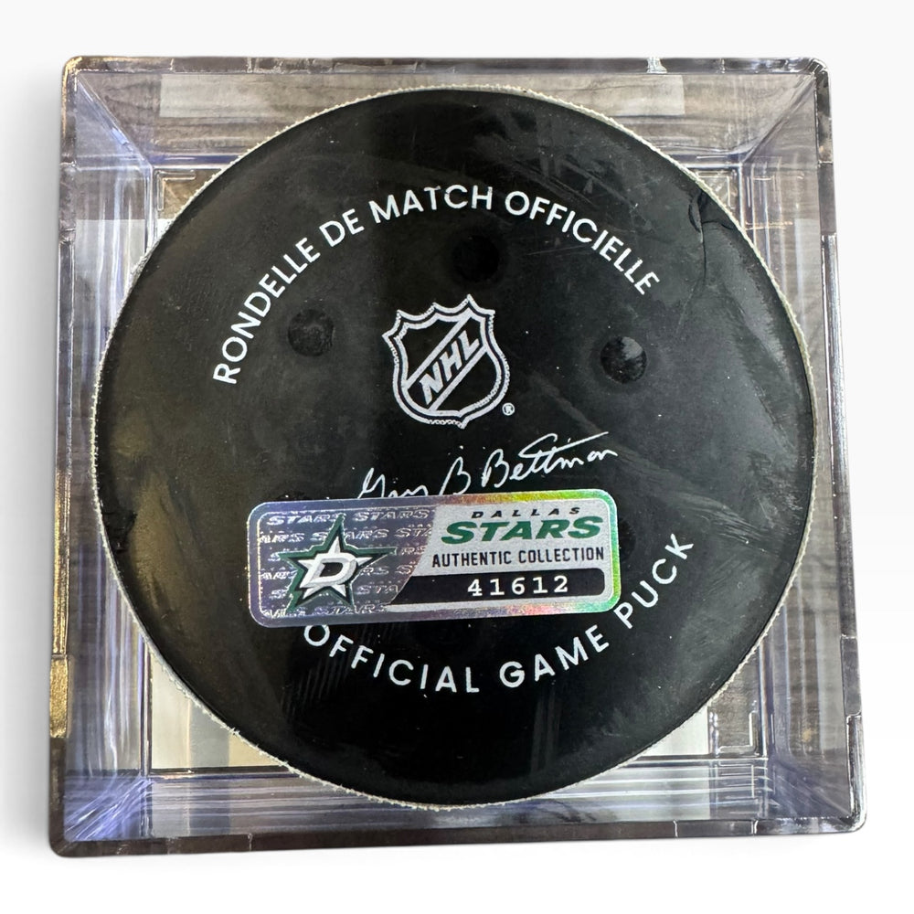 Official Dallas Stars NHL game puck in a clear square display case, featuring the black puck with white text and the Dallas Stars logo.