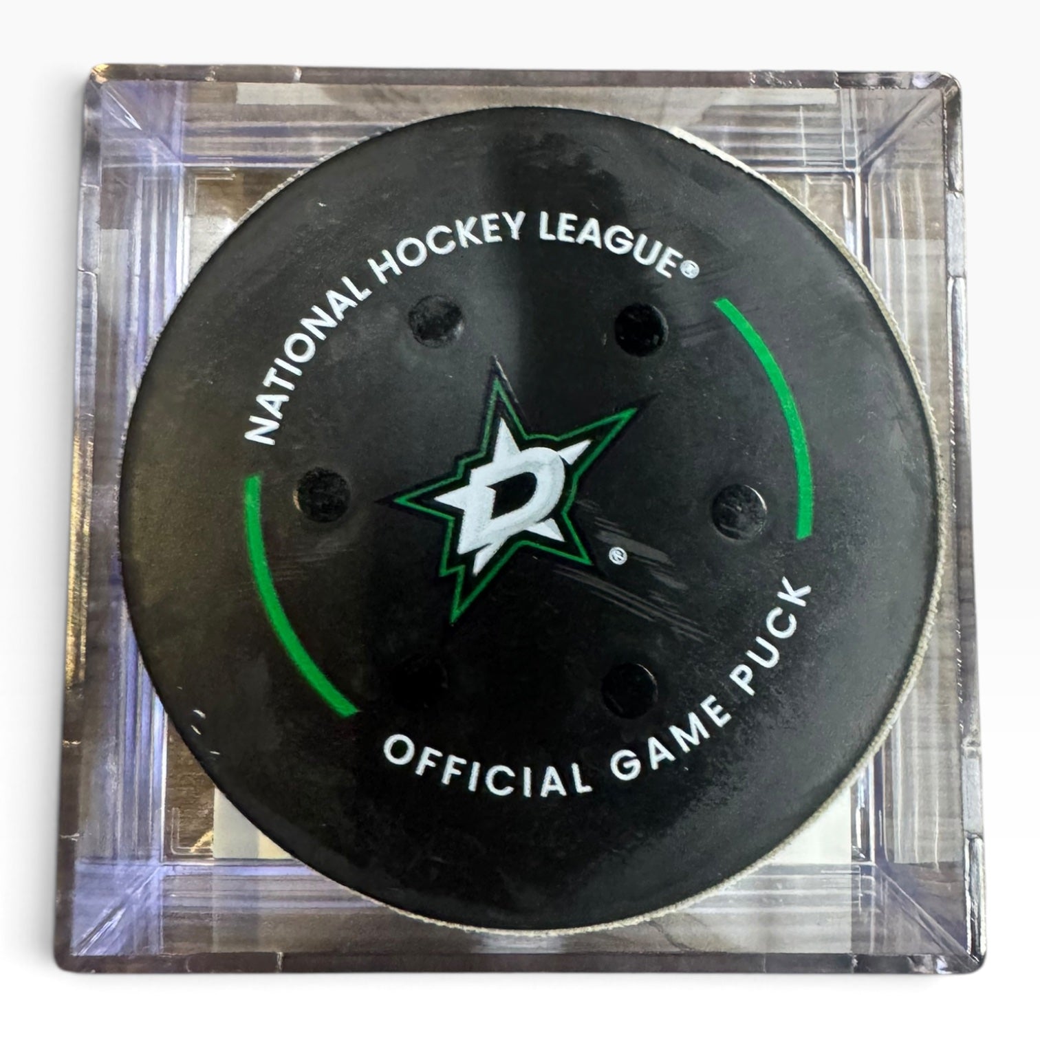 A Dallas Stars National Hockey League official game puck displayed inside a clear square acrylic case on a white background.