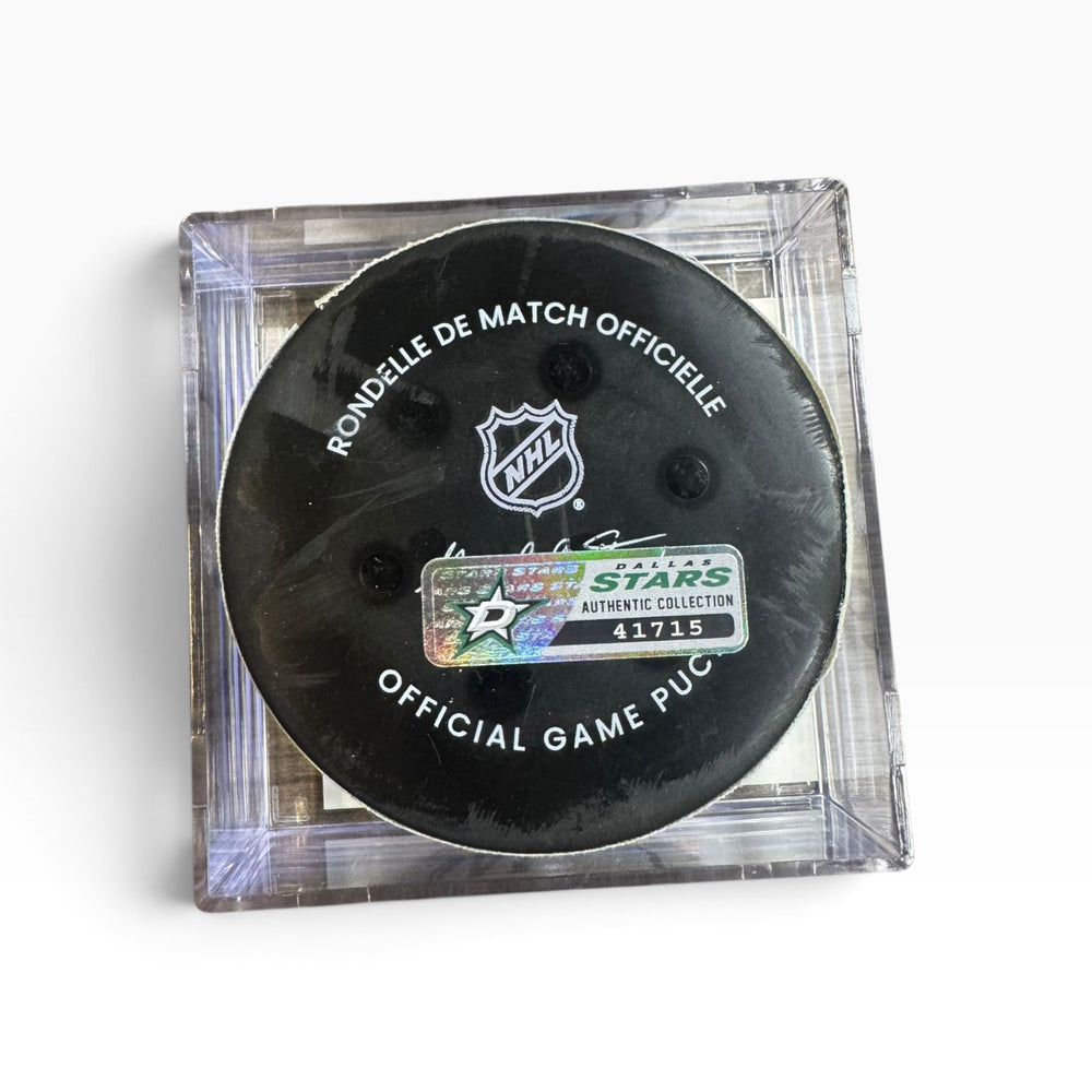 An official NHL hockey puck in a clear acrylic display case, featuring a black puck with white text and the NHL shield logo.