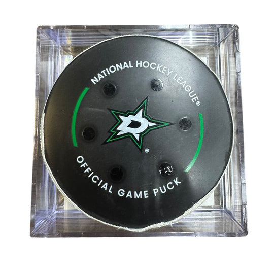 A Dallas Stars NHL official game/goal puck inside a clear plastic protective case, shown against a plain white background.