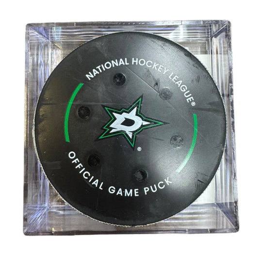 A Dallas Stars NHL official game/goal puck inside a clear plastic protective case, shown against a plain white background.