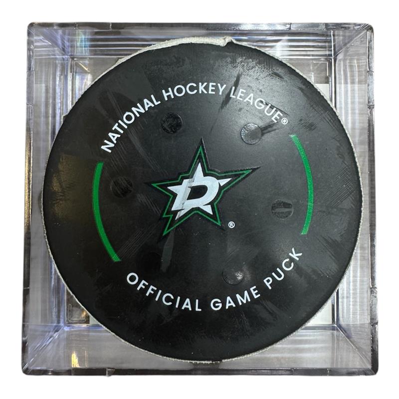 A Dallas Stars NHL official game/goal puck inside a clear plastic protective case, shown against a plain white background.