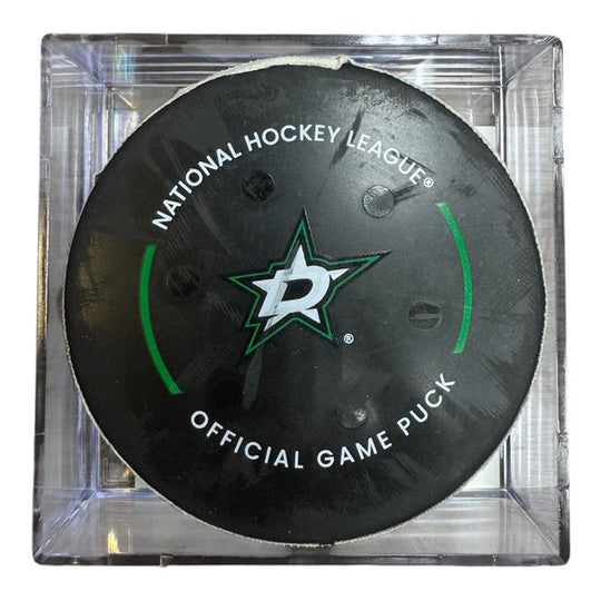 A Dallas Stars NHL official game/goal puck inside a clear plastic protective case, shown against a plain white background.
