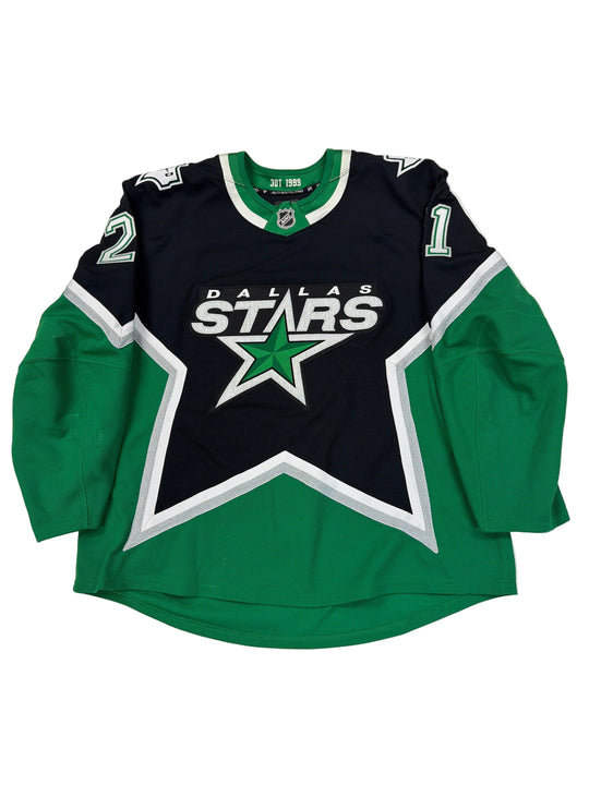 Green and black sports jersey with star logo on a white surface