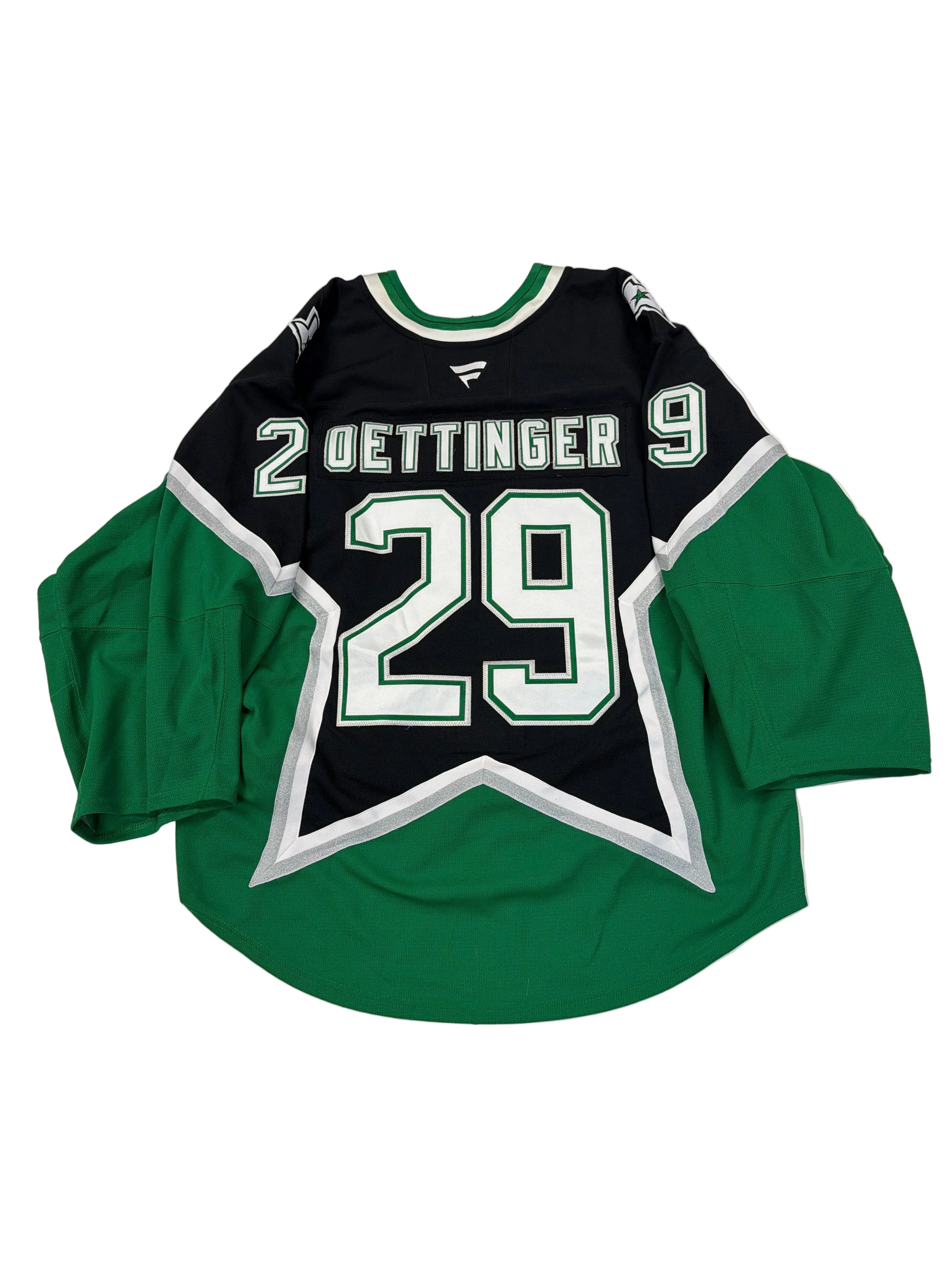 Green and black sports jersey with number 29 on a white surface