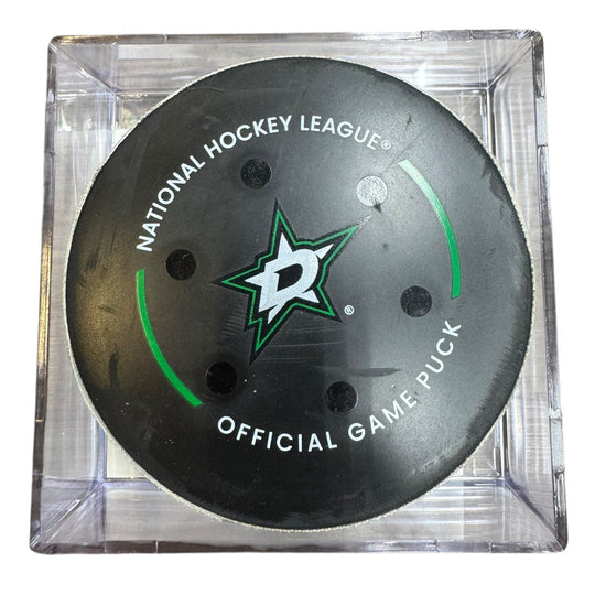 A Dallas Stars NHL official game/goal puck inside a clear plastic protective case, shown against a plain white background.