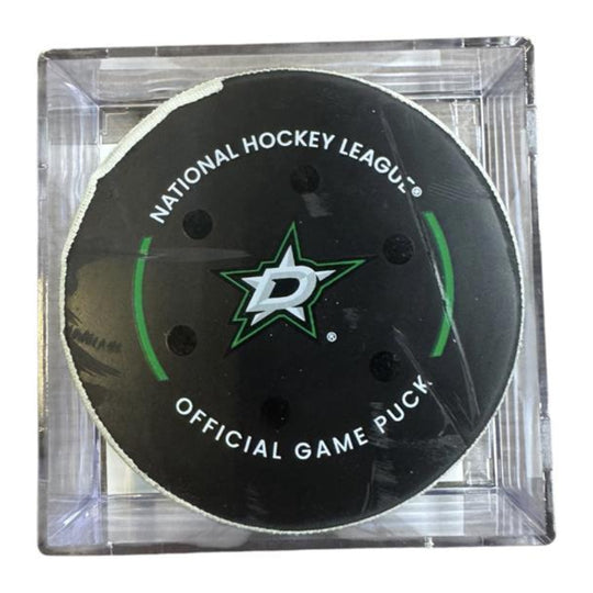 A Dallas Stars NHL official game/goal puck inside a clear plastic protective case, shown against a plain white background.