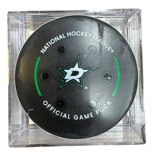 A Dallas Stars NHL official game/goal puck inside a clear plastic protective case, shown against a plain white background.