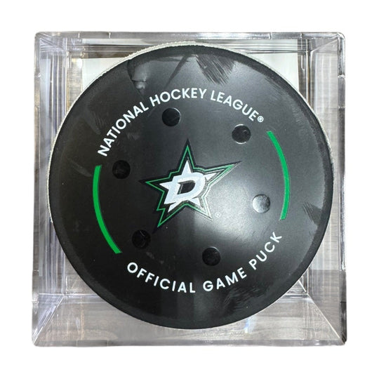 A Dallas Stars NHL official game/goal puck inside a clear plastic protective case, shown against a plain white background.