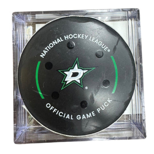 A Dallas Stars NHL official game/goal puck inside a clear plastic protective case, shown against a plain white background.