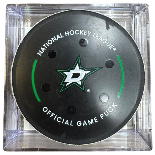 A Dallas Stars NHL official game/goal puck inside a clear plastic protective case, shown against a plain white background.