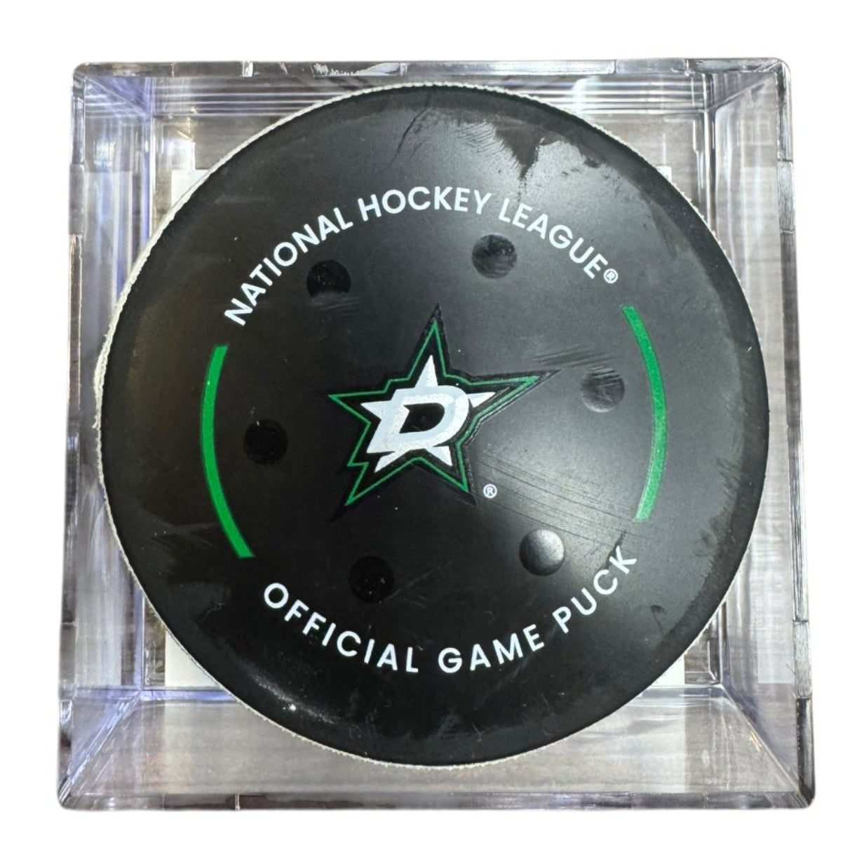 A Dallas Stars NHL official game/goal puck inside a clear plastic protective case, shown against a plain white background.