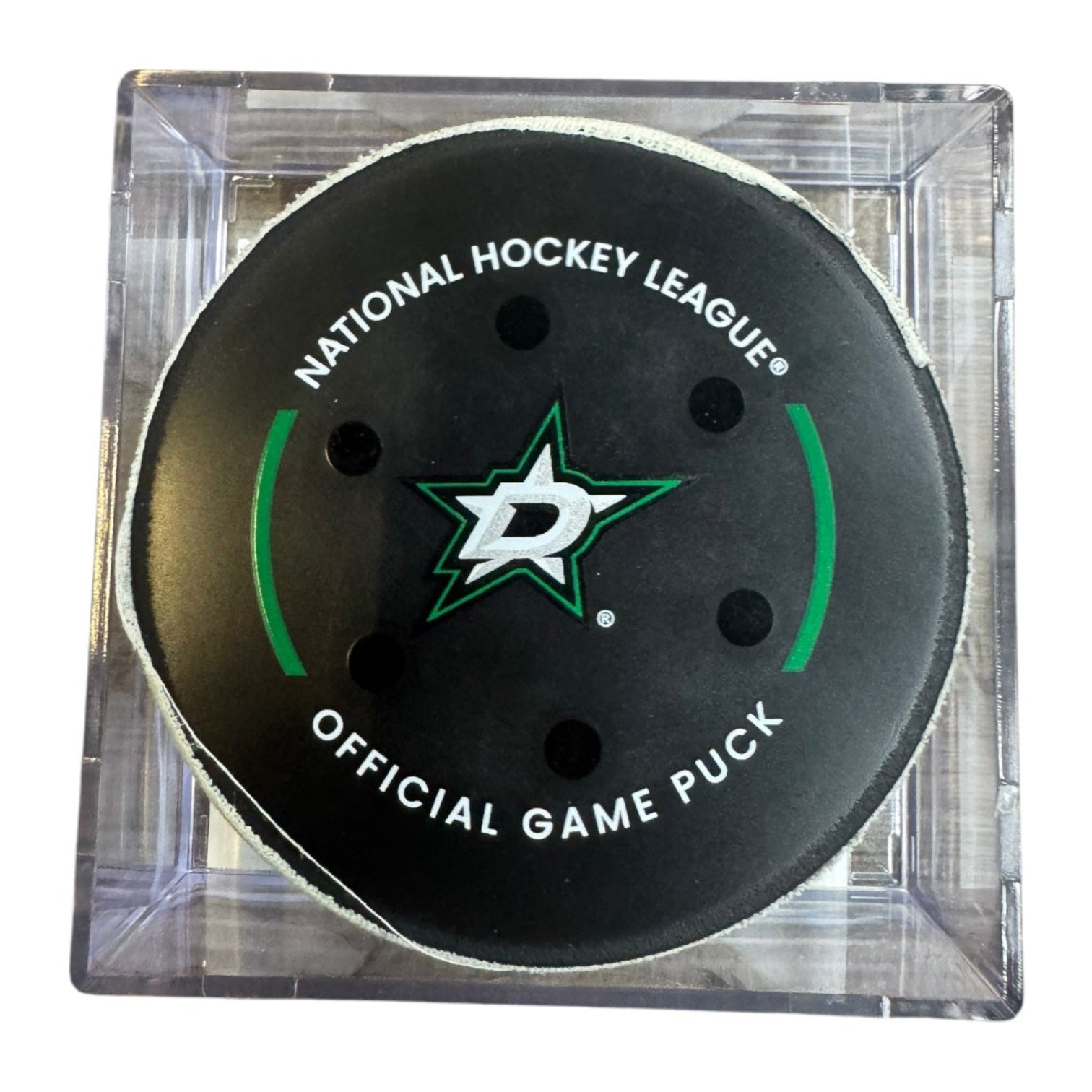 A Dallas Stars NHL official game/goal puck inside a clear plastic protective case, shown against a plain white background.