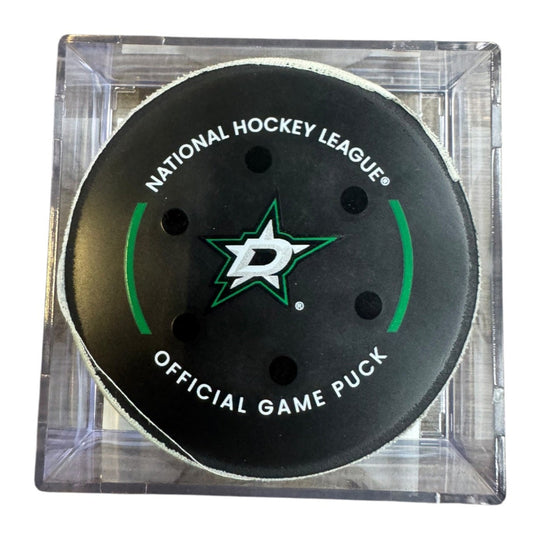 A Dallas Stars NHL official game/goal puck inside a clear plastic protective case, shown against a plain white background.
