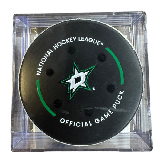 A Dallas Stars NHL official game/goal puck inside a clear plastic protective case, shown against a plain white background.