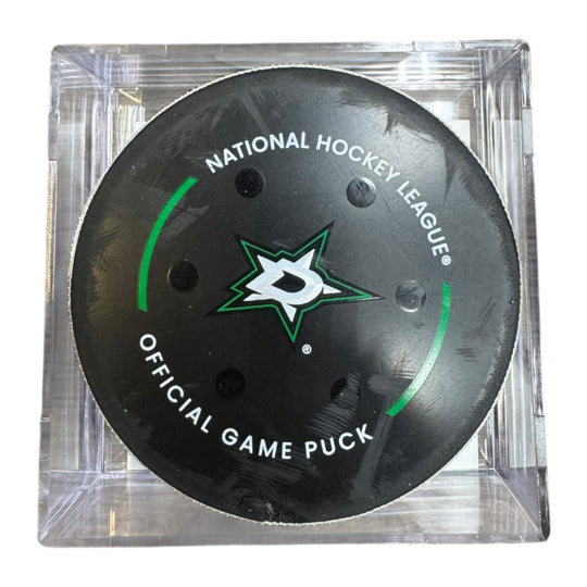 A Dallas Stars NHL official game/goal puck inside a clear plastic protective case, shown against a plain white background.