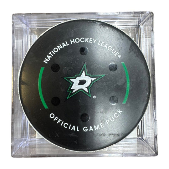 A Dallas Stars NHL official game/goal puck inside a clear plastic protective case, shown against a plain white background.
