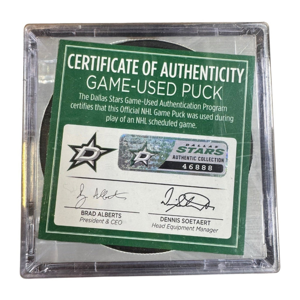 A game-used hockey puck in a clear plastic protective case with a green and white Certificate of Authenticity insert. COA #  46888
