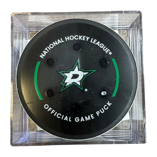 A Dallas Stars NHL official game/goal puck inside a clear plastic protective case, shown against a plain white background.