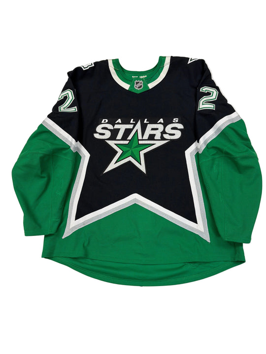 Green and black hoodie with a star logo on a white surface