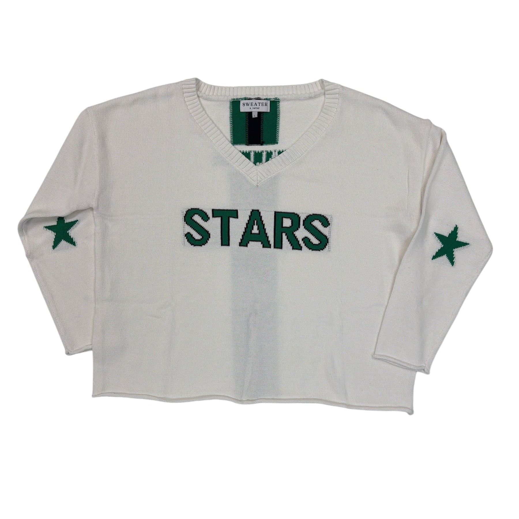 White sweater with 'STARS' text and green stars on a white background