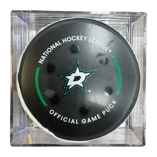 A Dallas Stars NHL official game/goal puck inside a clear plastic protective case, shown against a plain white background.