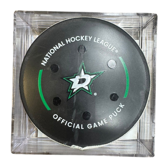 A Dallas Stars NHL official game/goal puck inside a clear plastic protective case, shown against a plain white background.
