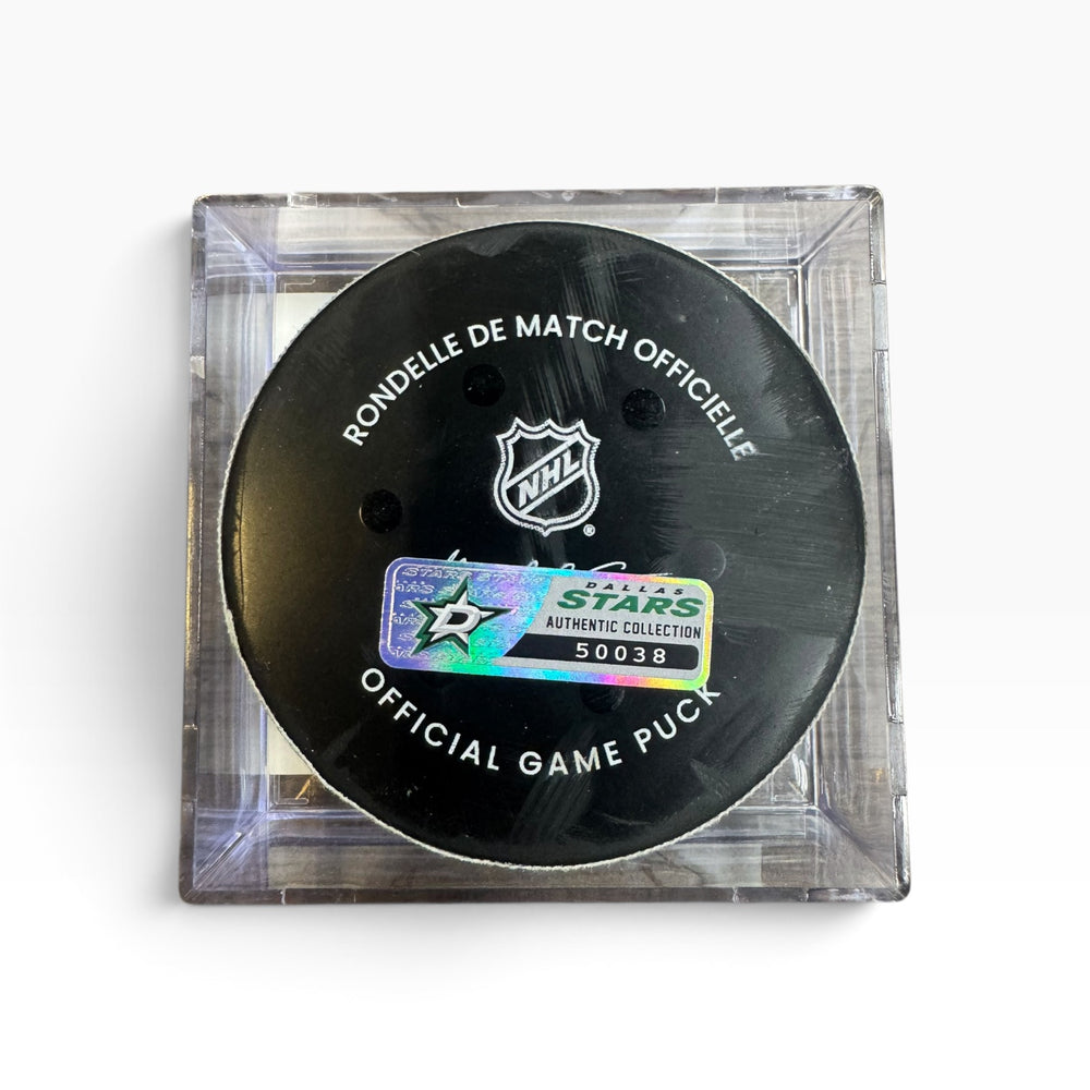 An official NHL hockey game puck in a clear square plastic case, featuring a black puck with white text and the NHL shield logo, plus a holographic Star Authentic collectible sticker.