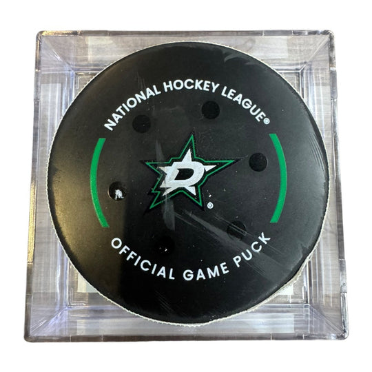A Dallas Stars NHL official game/goal puck inside a clear plastic protective case, shown against a plain white background.