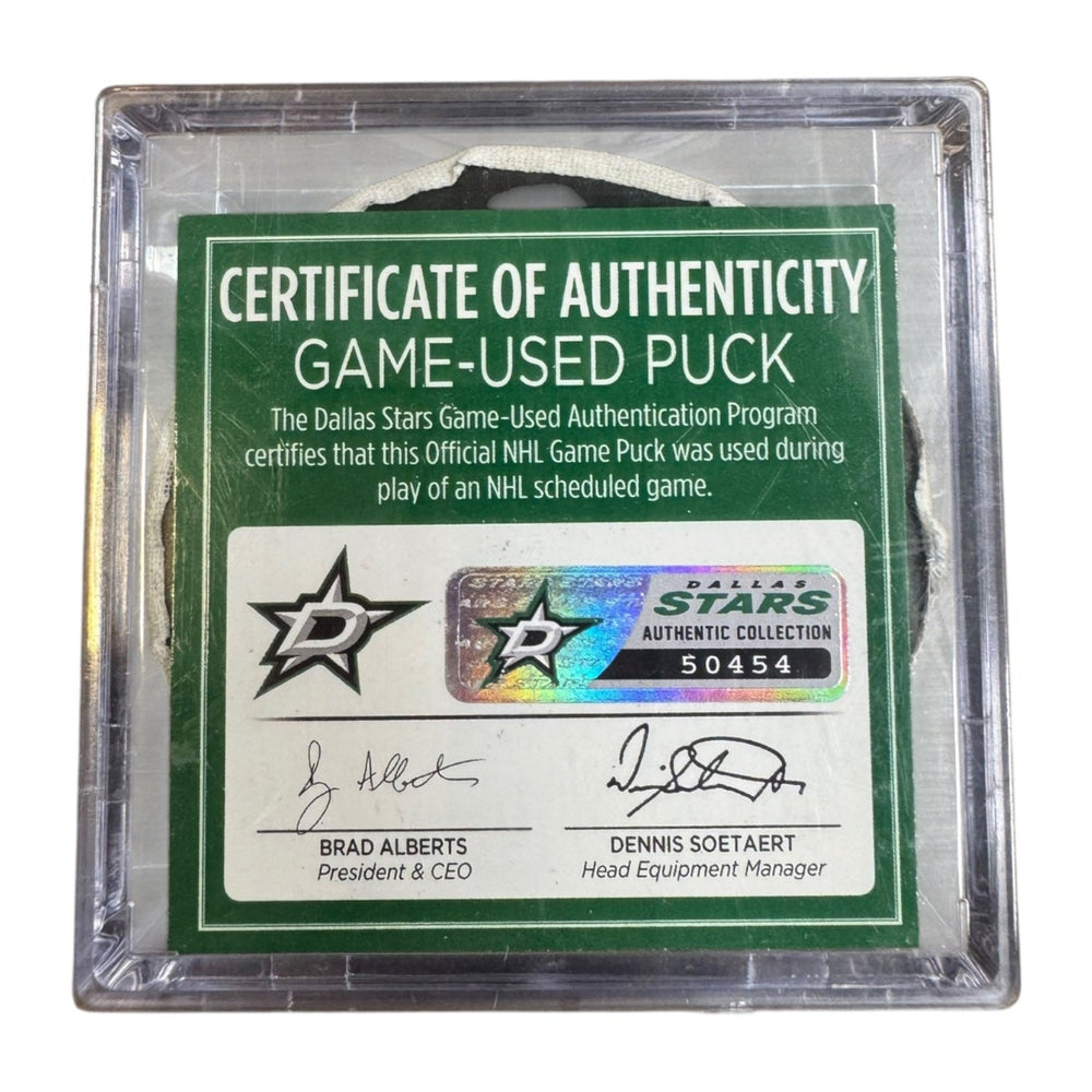 A game-used hockey puck in a clear plastic protective case with a green and white Certificate of Authenticity insert. COA #  50454
