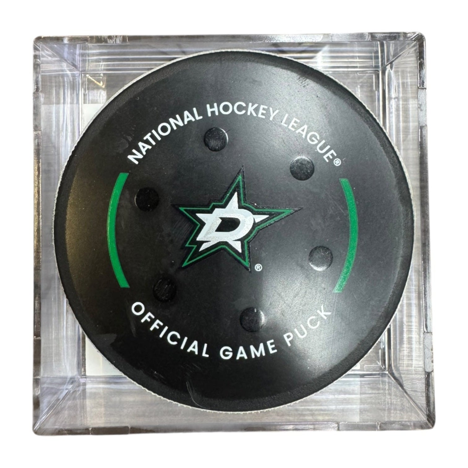 A Dallas Stars NHL official game/goal puck inside a clear plastic protective case, shown against a plain white background.
