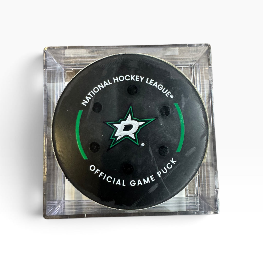A Dallas Stars National Hockey League official game puck in a clear acrylic block display, on a white background.