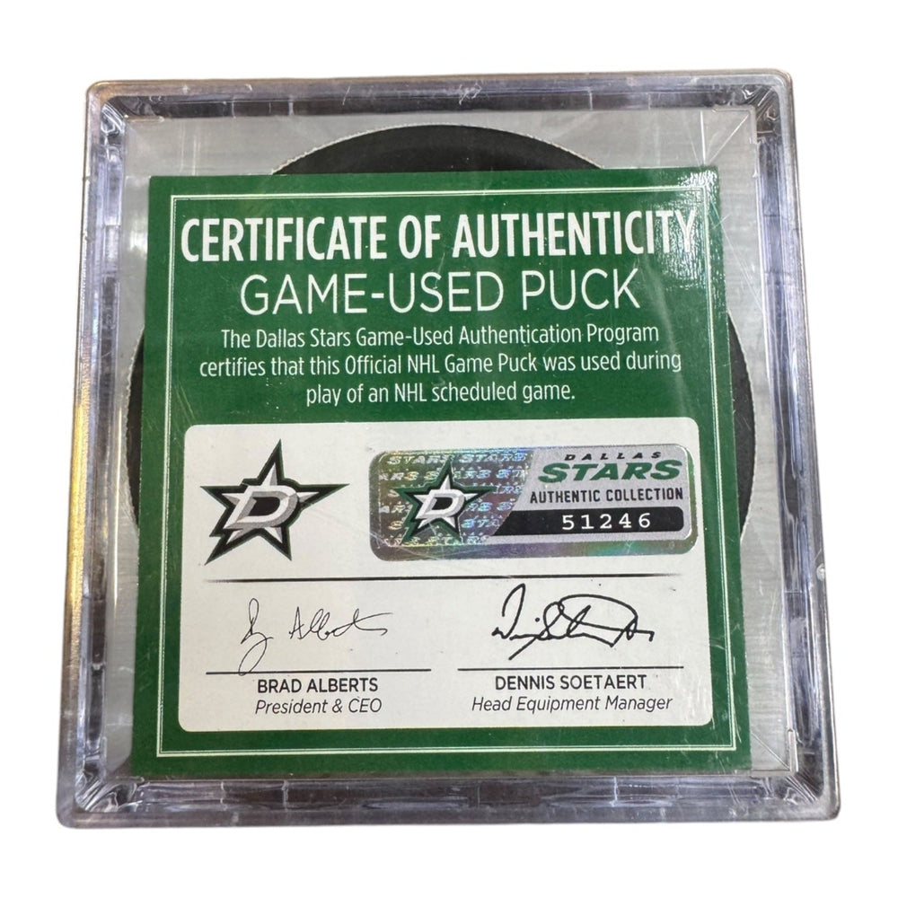 A game-used hockey puck in a clear plastic protective case with a green and white Certificate of Authenticity insert. COA #  51246
