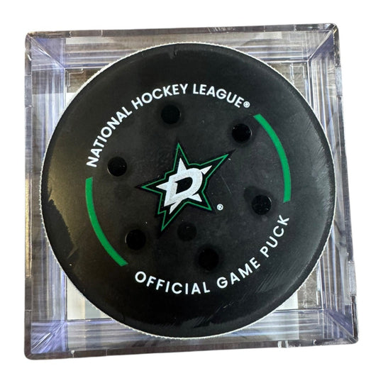 A Dallas Stars NHL official game/goal puck inside a clear plastic protective case, shown against a plain white background.
