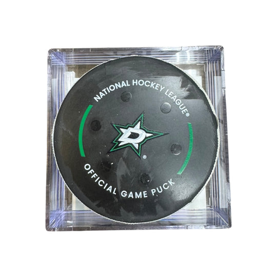 A Dallas Stars NHL official game/goal puck inside a clear plastic protective case, shown against a plain white background.