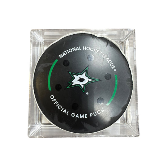 A Dallas Stars NHL official game/goal puck inside a clear plastic protective case, shown against a plain white background.