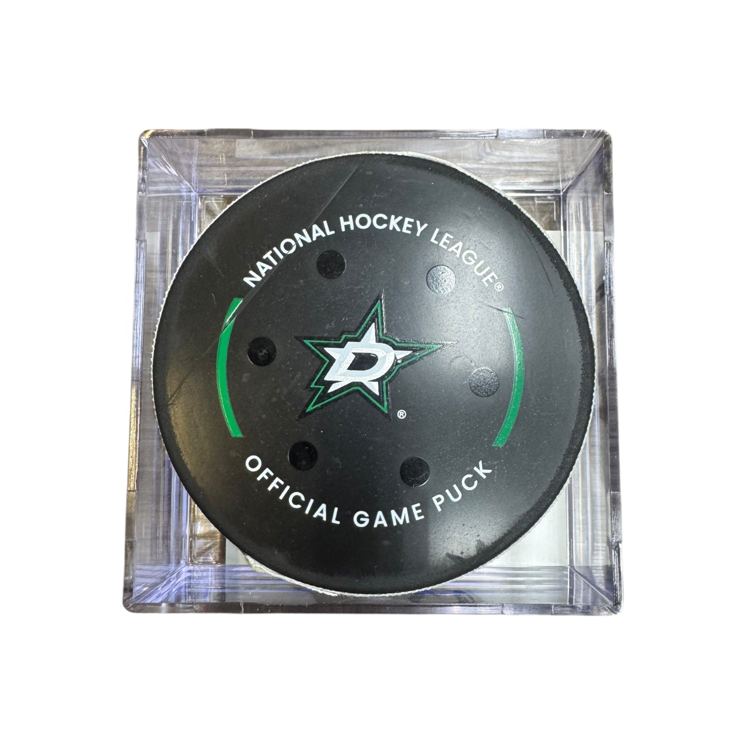 A Dallas Stars NHL official game/goal puck inside a clear plastic protective case, shown against a plain white background.