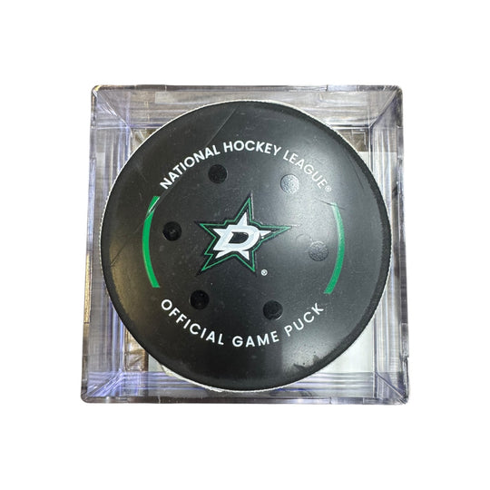 A Dallas Stars NHL official game/goal puck inside a clear plastic protective case, shown against a plain white background.